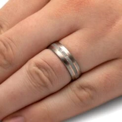 Meteorite Wedding Band With Rose Gold Pinstripes -Johan Jewelry Shop 3853 Handshot 132d80a0 816c 44a5 87d6 22562ca31b47