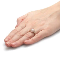 Yellow Gold Halo Engagement Ring With Emerald Accents -Johan Jewelry Shop E2554Handshot 1dce5f5c ef6d 4191 bfbb 2646dcdc17c3