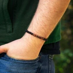 Penton Dinosaur Bone & Lava Bead Bracelet 15 Penton Dinosaur Bone & Lava Bead Bracelet -Johan Jewelry Shop E 4163 Handshot October Cropped 3